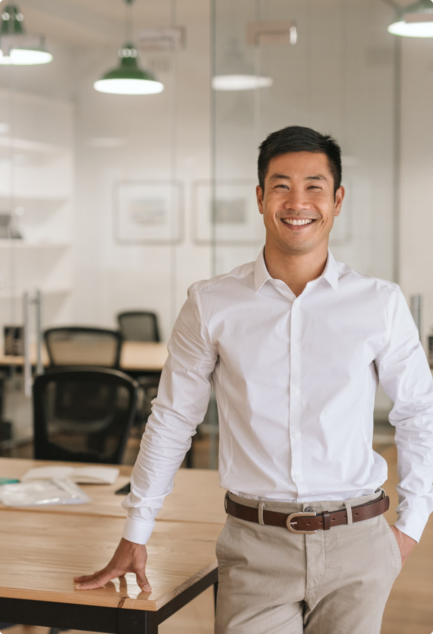 Businessman Standing in Office Smiling