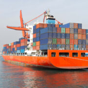 Shipping vessel with containers docked at a port